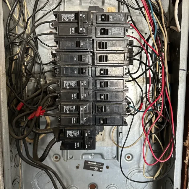 An electrical panel before an electrical service upgrade